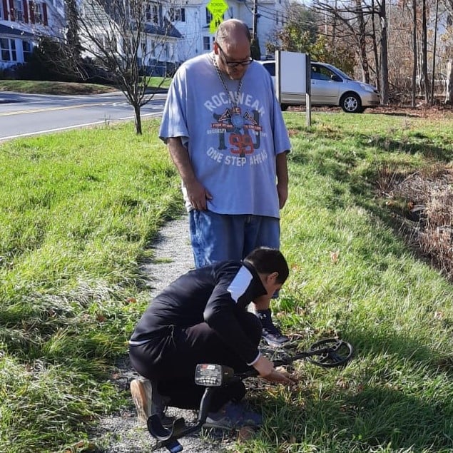 men using metal detector